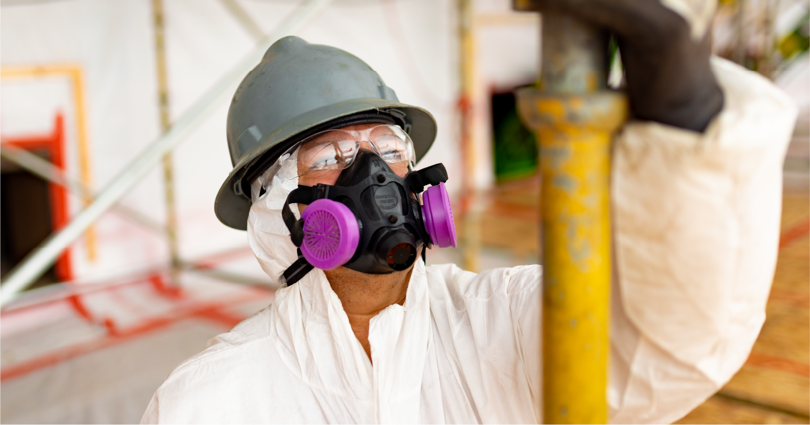 Man wearing Hazmat suit and mask with air filters