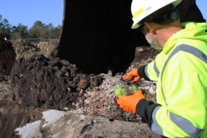 man takes soil sample